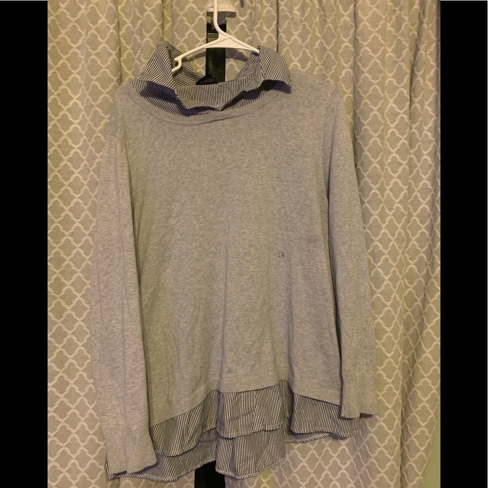 Grey top with blue and white collar and sleeves